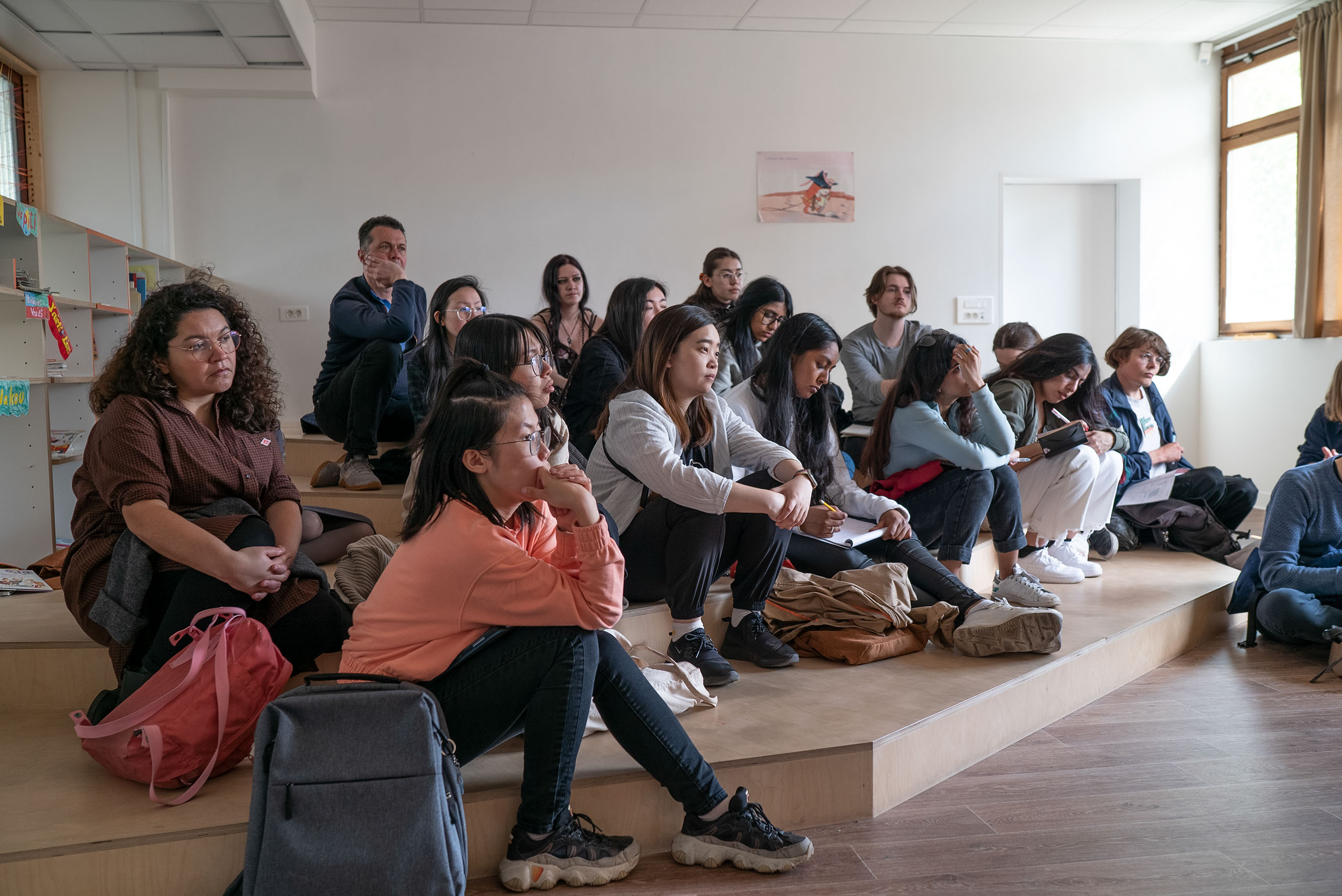 Group of students sitting on the floor of a classroom