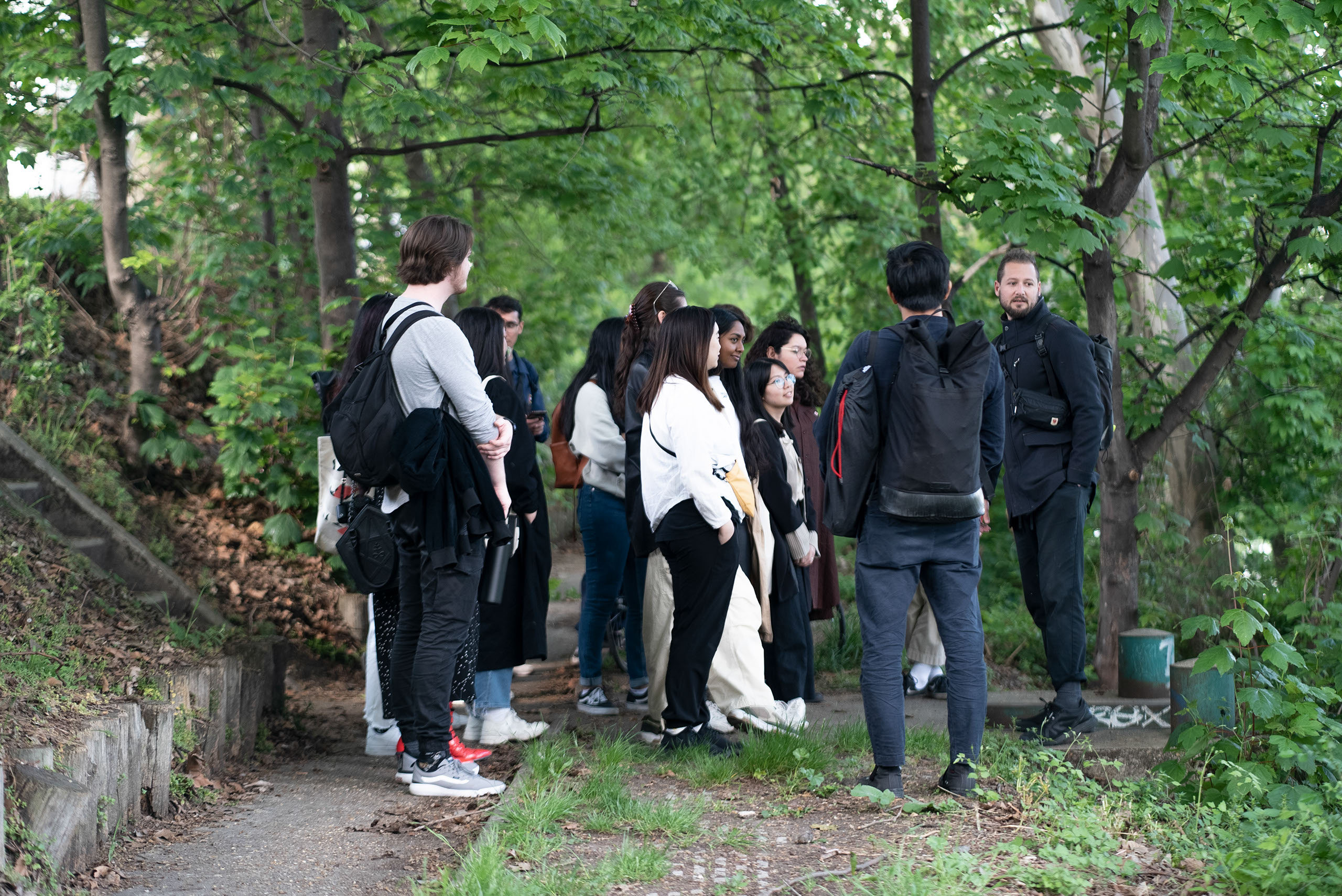 Students gathered in a group in a green hiking trail