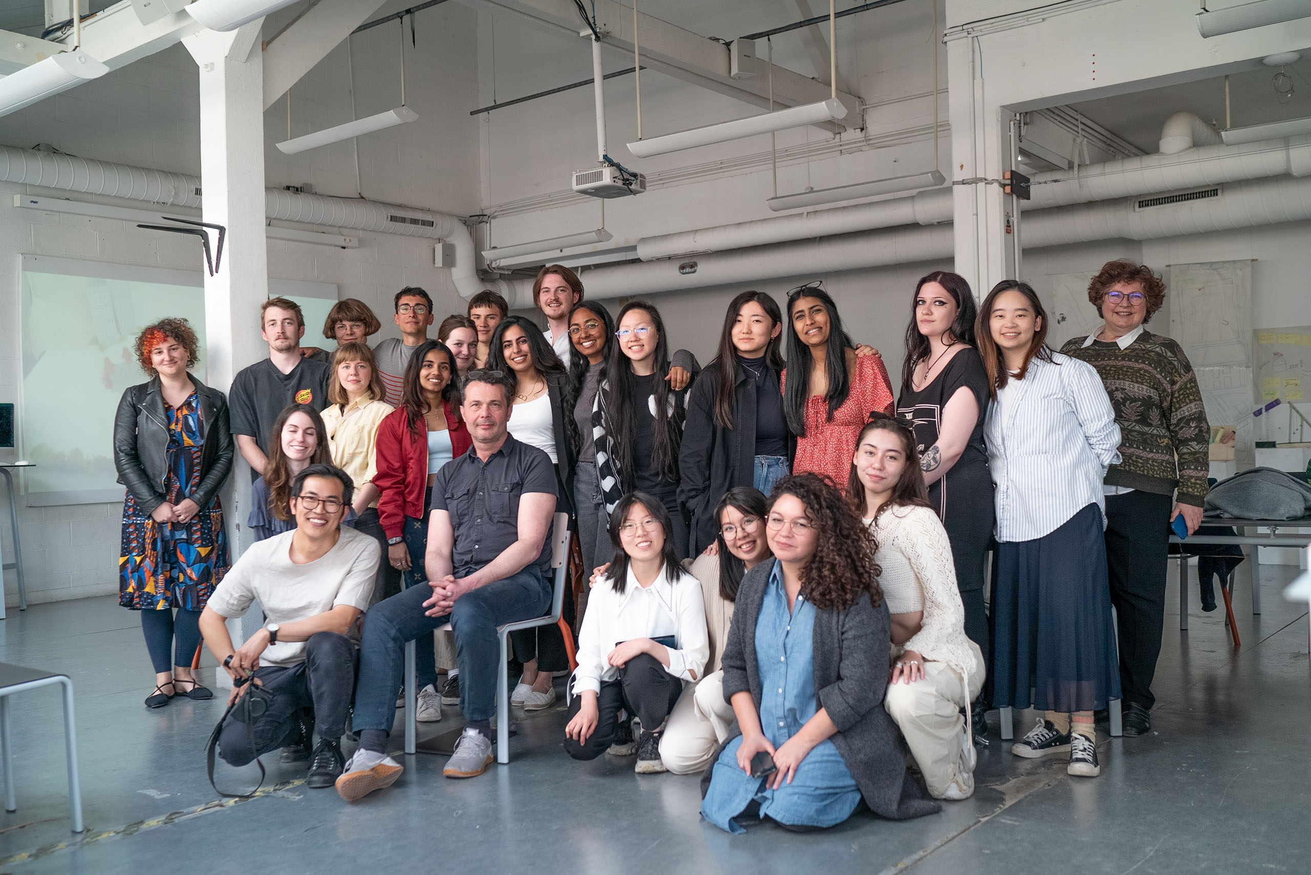 Group of students standing together for a group photo in a studio