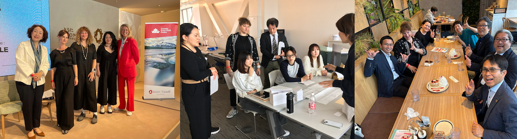 People gathered around desk looking towards paper sculpture