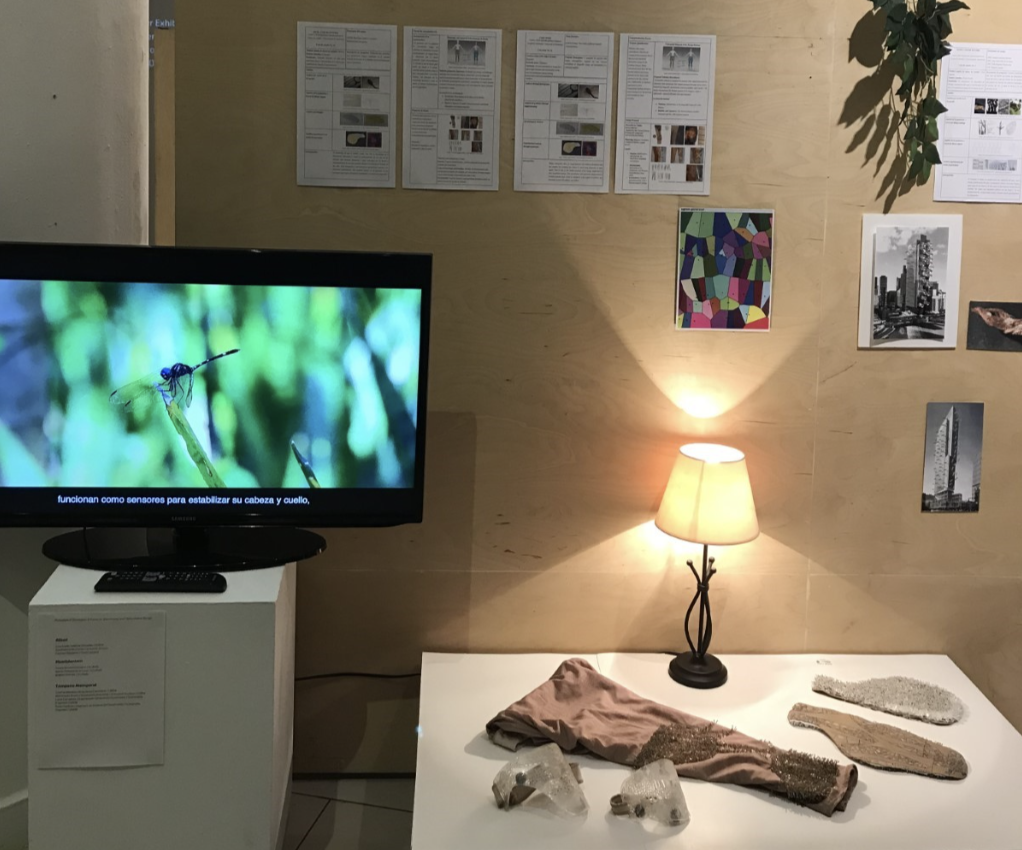 A lamp on a table with a small screen beside it