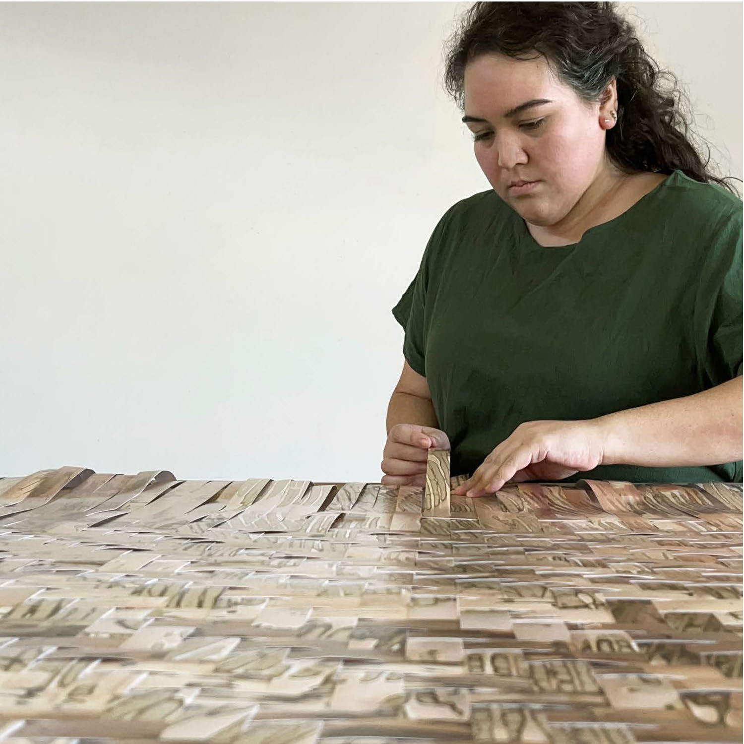 Person weaving paper strips