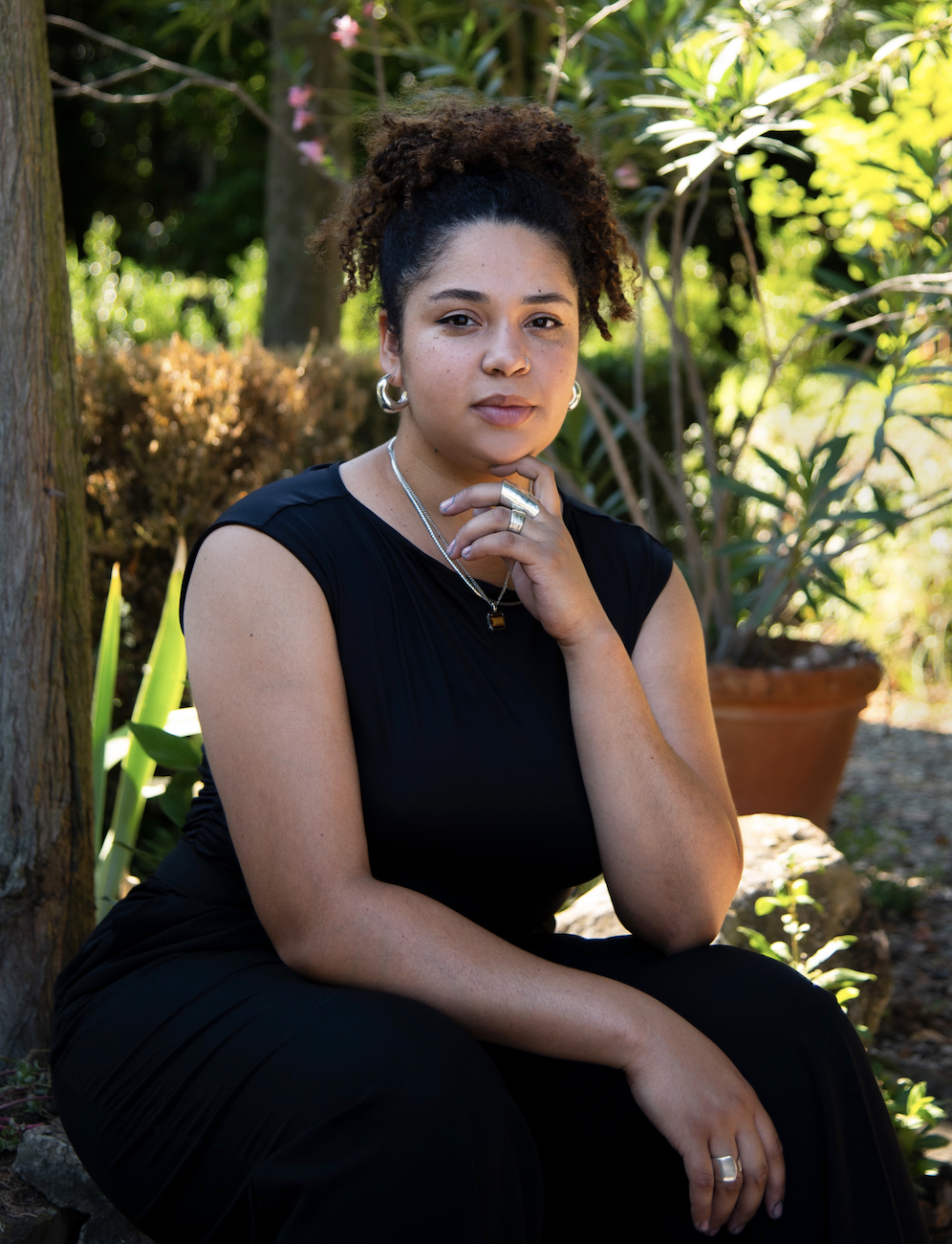 A woman with short black hair and wearing black dress