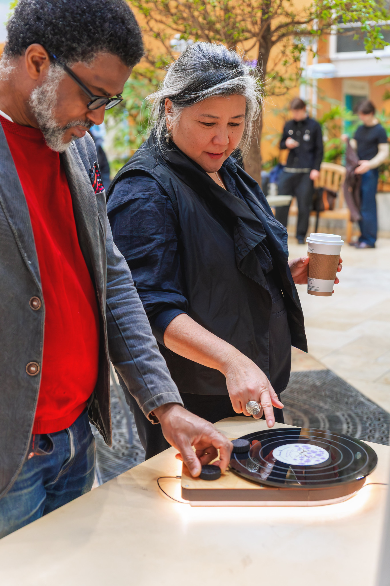 President Ana Serrano examines a product on a table. 
