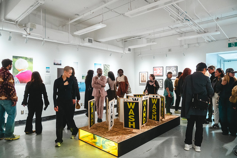 Visitors explore the gallery space at the printmaking section during GradEx 111