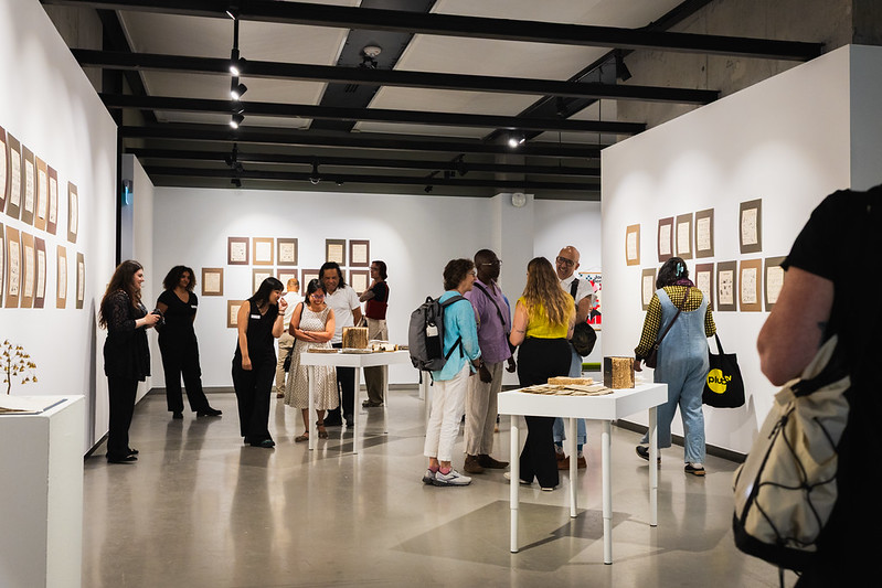 People looking at art work in a gallery.