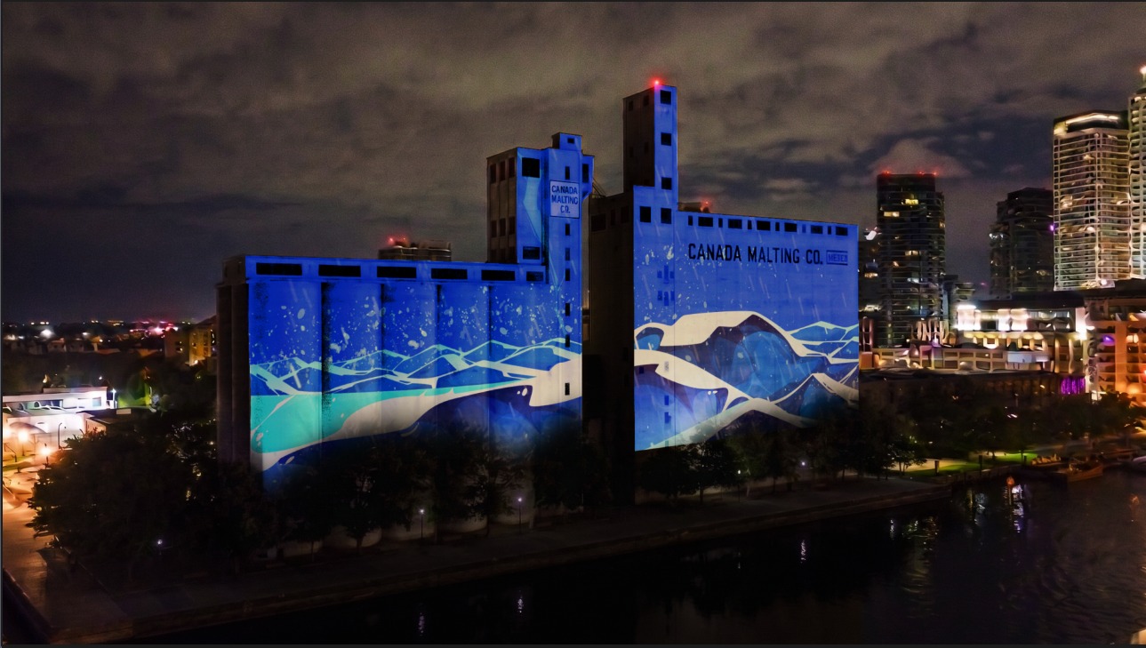 Artwork, "Breathe" of blue sky and land, projected onto Canada Malting Silos