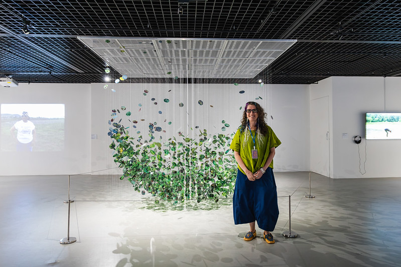 Woman standing in front of an artwork