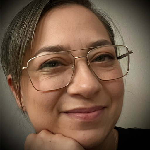 Head shot of Judith Librach, wearing glasses. 