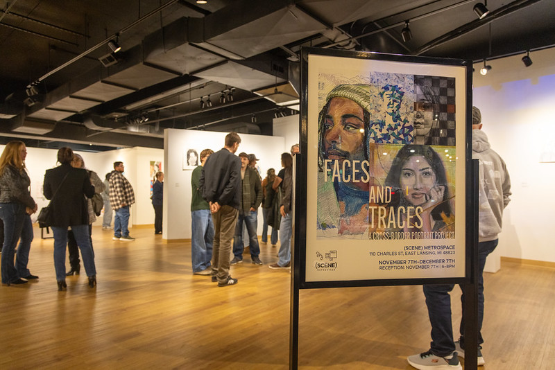 Exhibition gathering featuring poster.