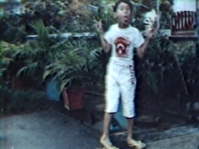 A shot of boy making funny face in a yard