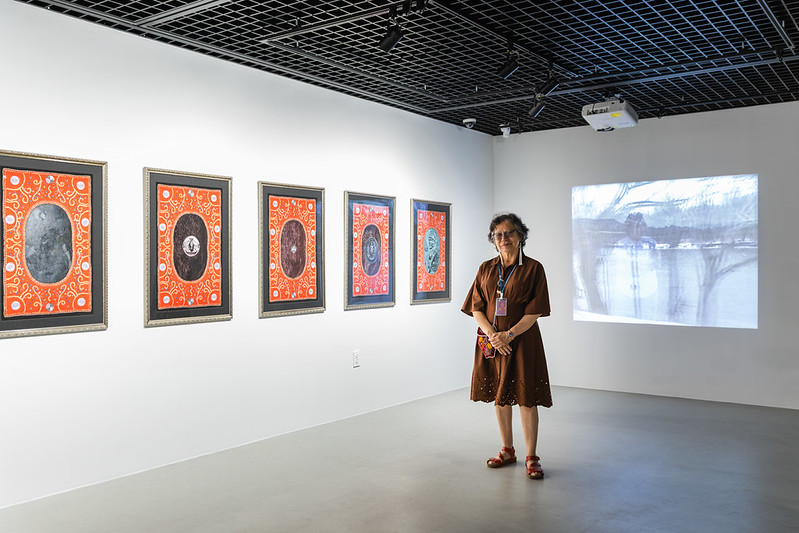 Artist Shelley Niro in front of her artwork