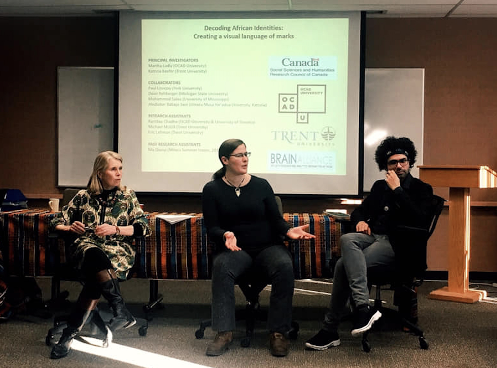 Ladly, Keefer and Chadha presenting at Harriet Tubman Institute Three people seated in front of a screen