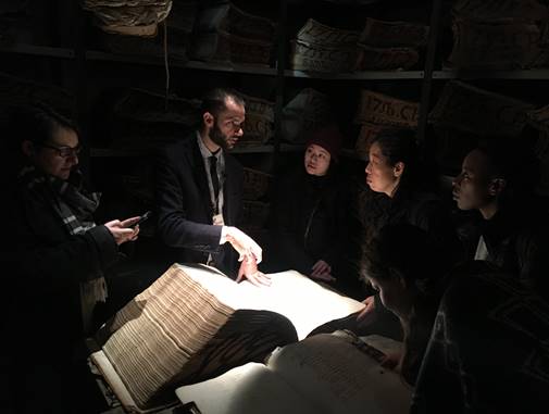 Dark light room people in discussion over a book