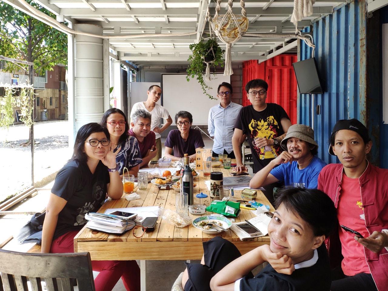 Members of ruangrupa seated around a table.