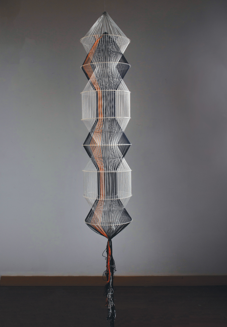 A symmetrical sculpture made of thread and acrylic. 