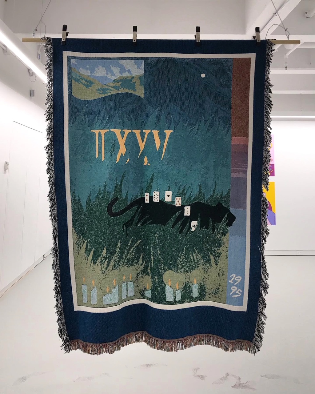 Photo documentation of Ocampo's jacquard loom textile hung from the ceiling in the gallery.