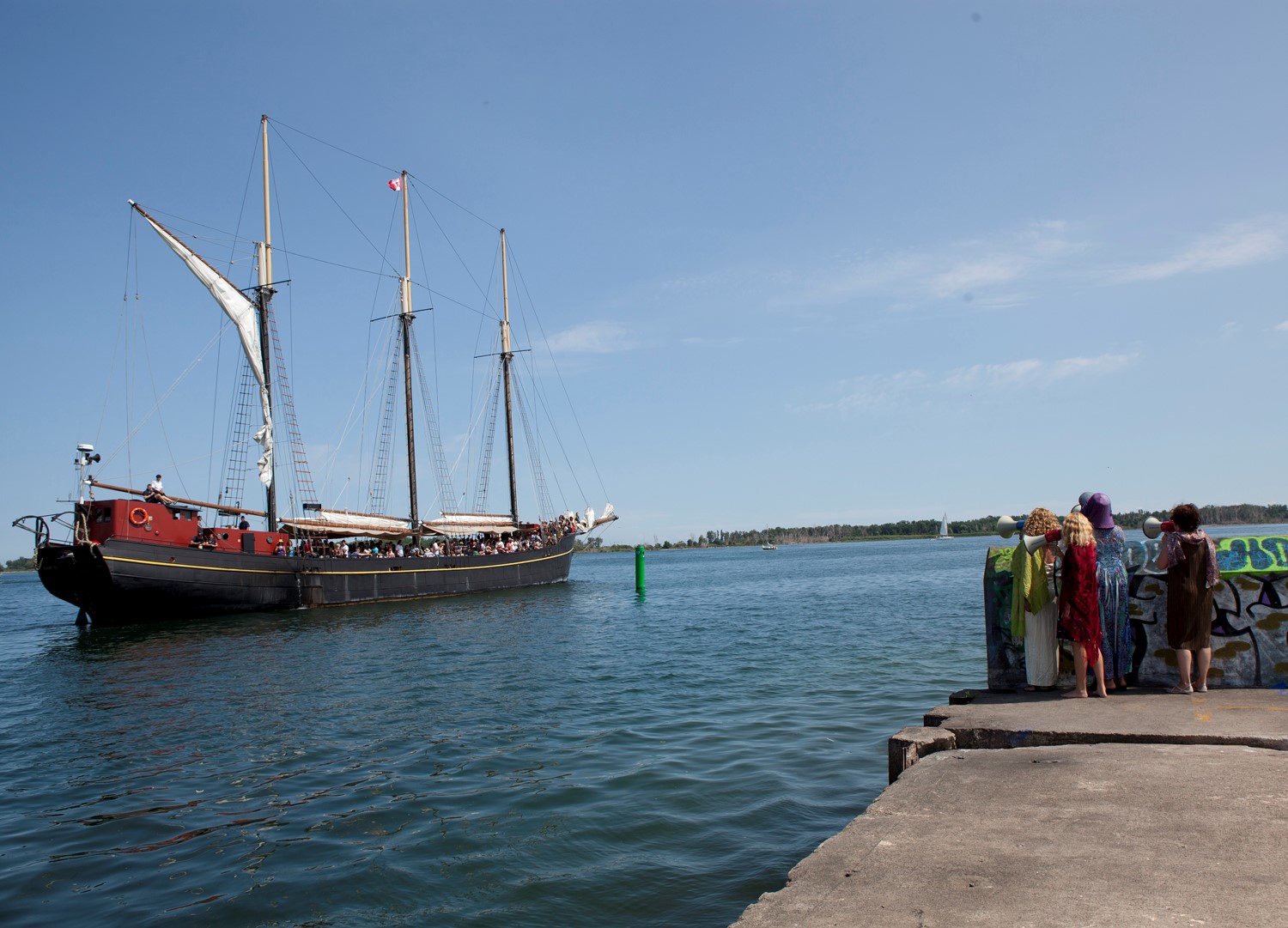 Siren I performance of women ululating to the passengers of a tall ship, location photograph. Performance at Kajama Boat Tour, ArtSpin Toronto, 2018. Photo: nichola feldman-kiss