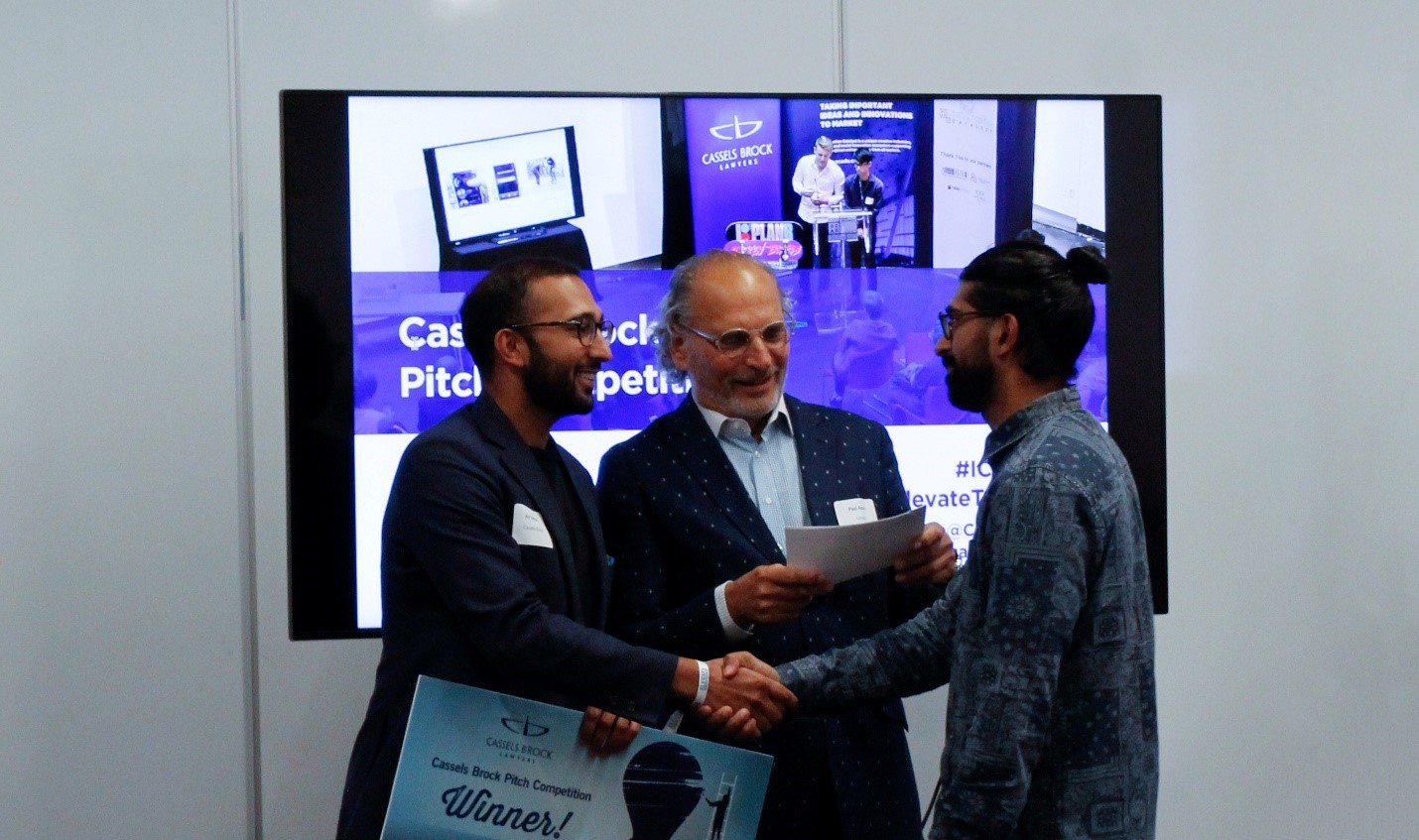 Pitch competition winner, Abid Virani, receives prize cheque from Cassels Brock’s Aly Somani. Photo courtesy, Valerie Poon.