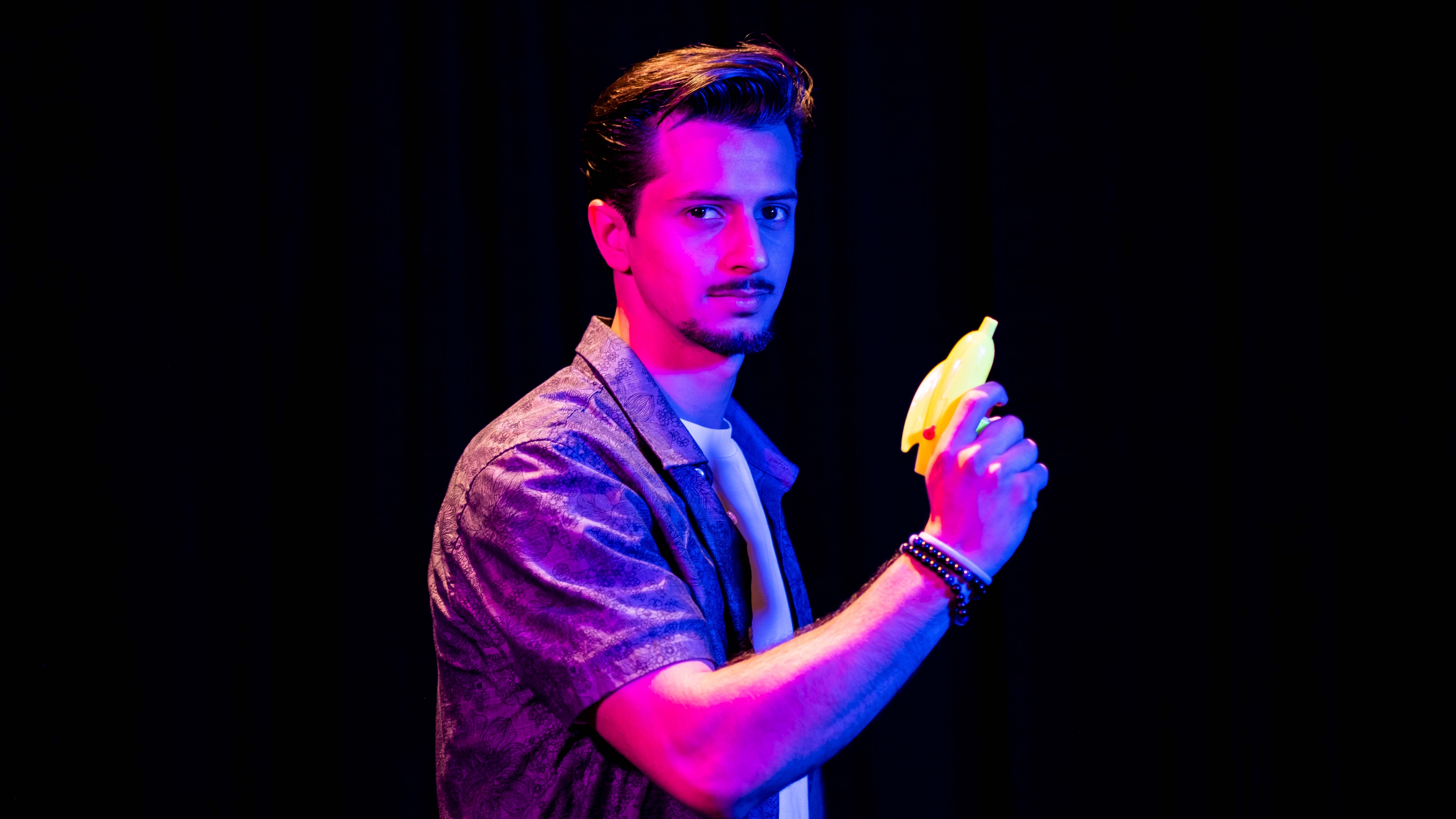 young man holding a toy water gun