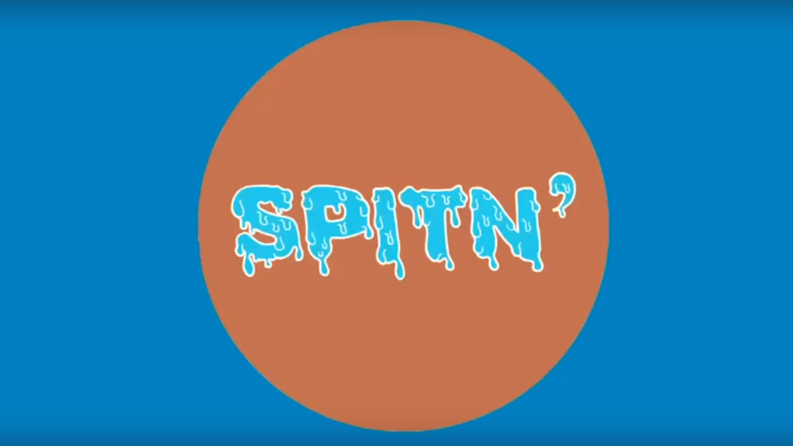 An image of an orange circle on a blue background. Inside the circle is the text "spiting".