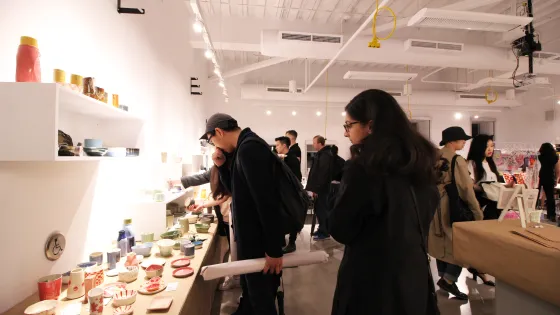 People viewing art for sale at a marketplace
