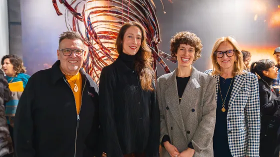 Group of people posing for a photo in an art gallery