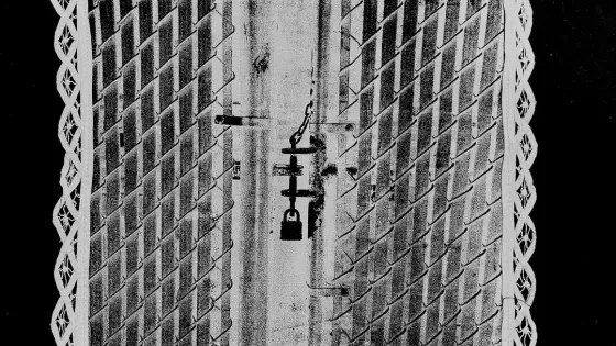 Black and white image of white square with a door with a lock on it