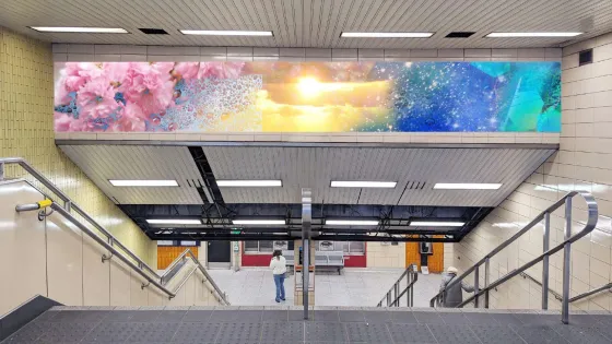 View of descending stairs at Christie Station with virtual mock-up of art installation overhead. 