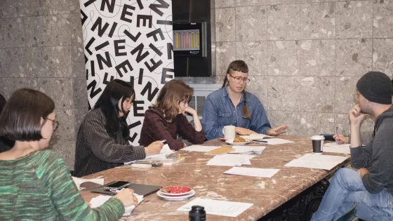 Group of people sitting around a table co-working