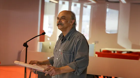An image of Dr. Ananda Shankar Chakrabarty standing at a podium.