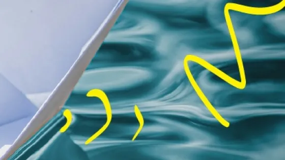 paper boat closeup on water with yellow accents