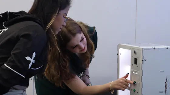 Two students looking at a project