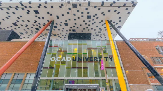 Photo of tabletop building over main OCAD U building with snow on the ground