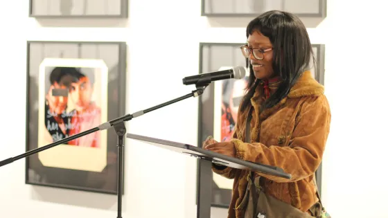 A woman speaking on a mic