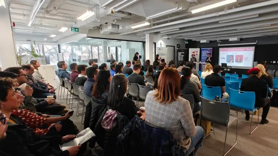 People sitting in an audience at a presentation. 