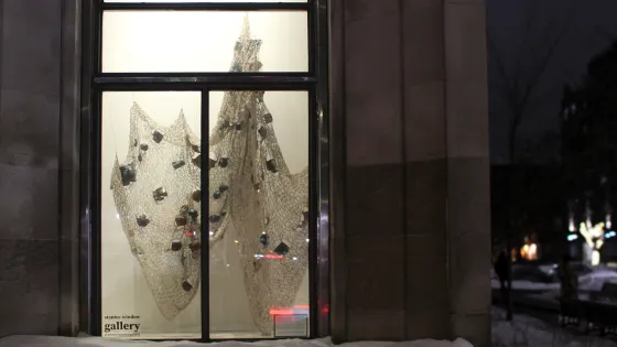 Textile based artwork on display behind gallery window
