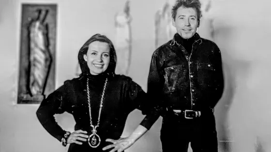 A woman and a man standing next to each other in a black and white photo