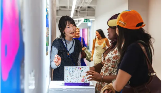 Student explaining work at an art show