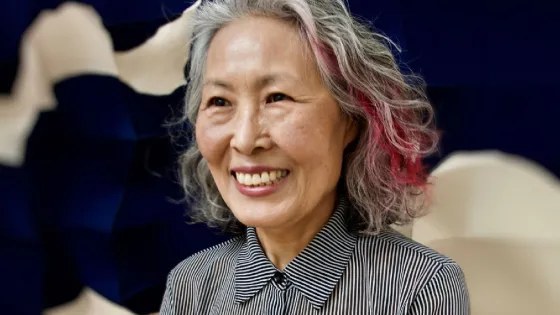Chung-Im Kim wearing black and white shirt.