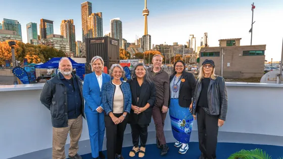 Group photo outside, with Toronto skyline in the back. 