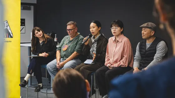 Panel of five people on a stage