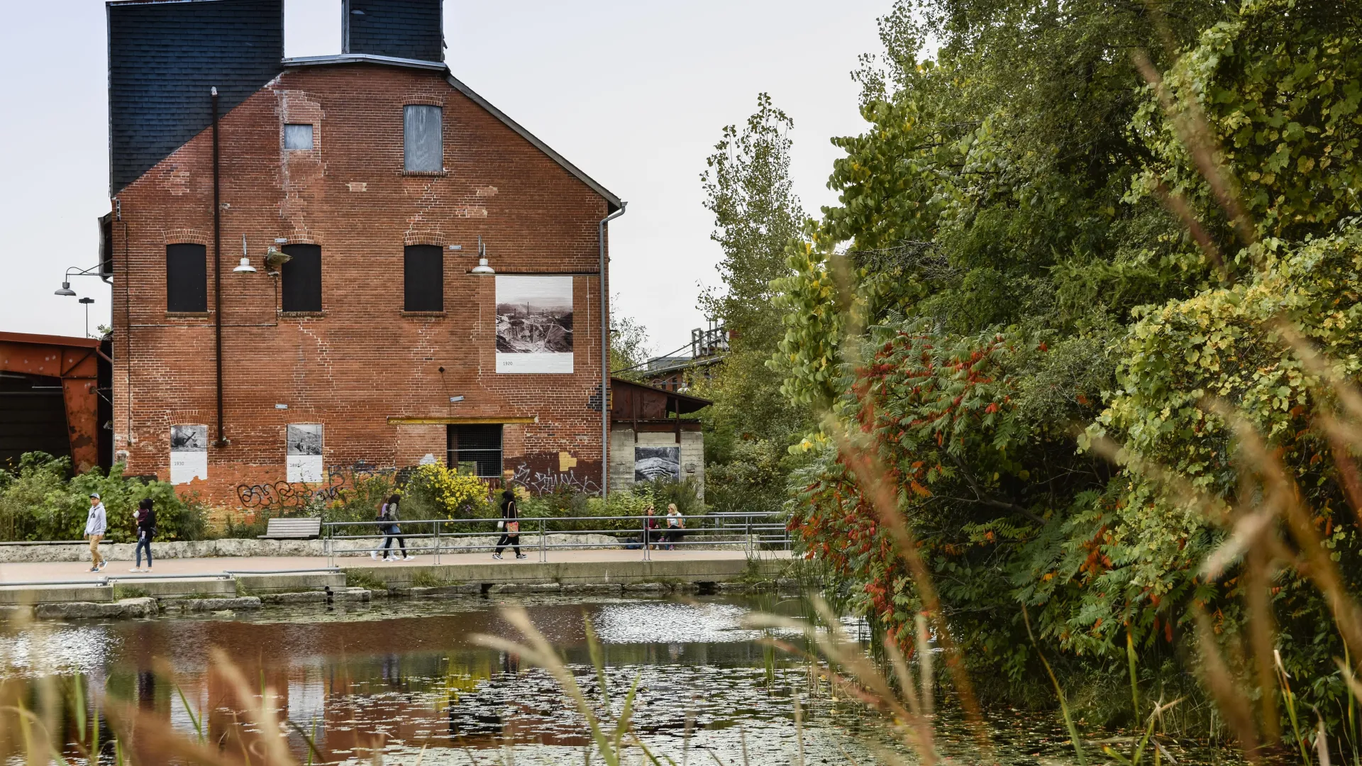 Brick building in front of a poind