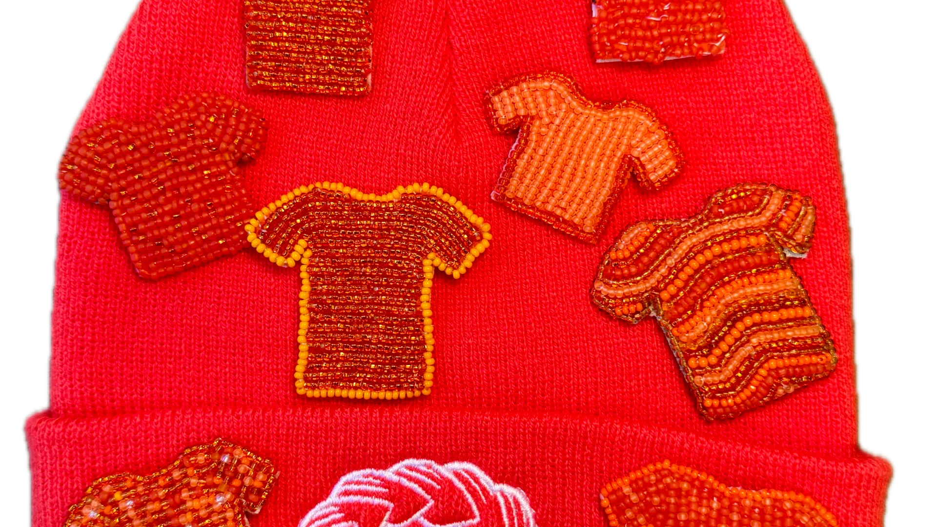 Orange Shirt Day pins resting on an Orange Shirt Day toque