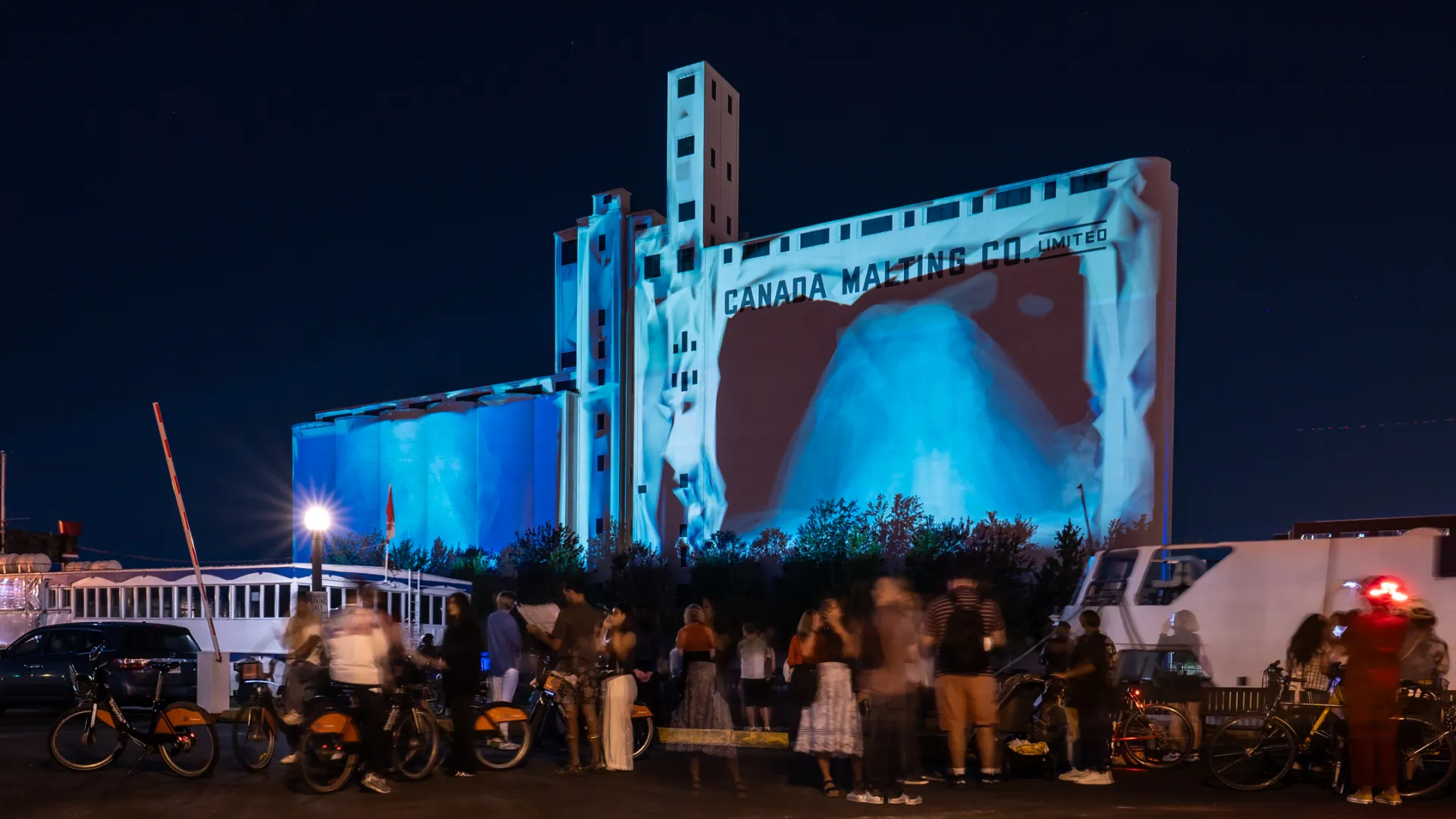 Crowd watching projection on Canada Malting Silos