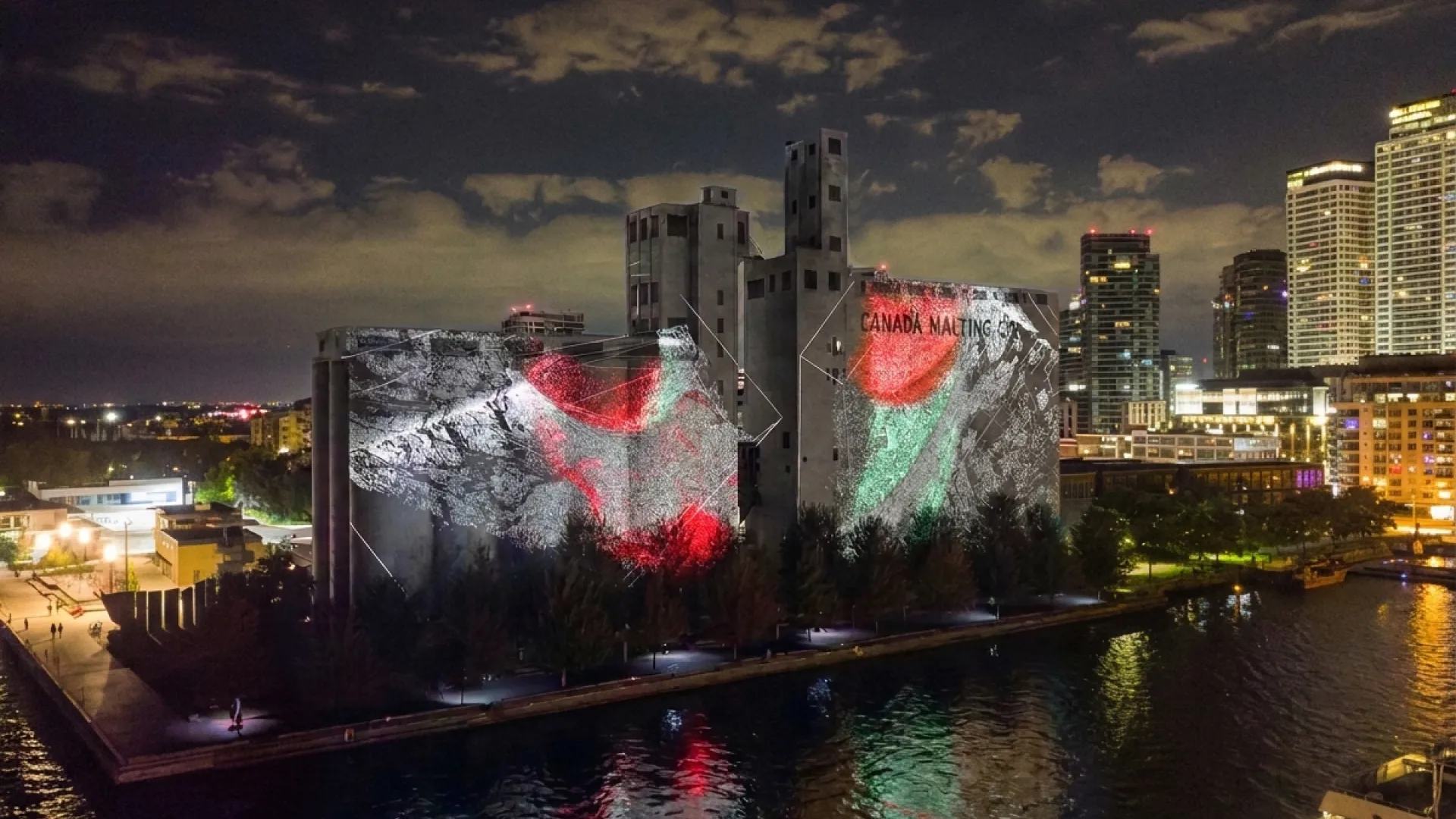 Projection of image of red, white and green on Canada Malting Silos