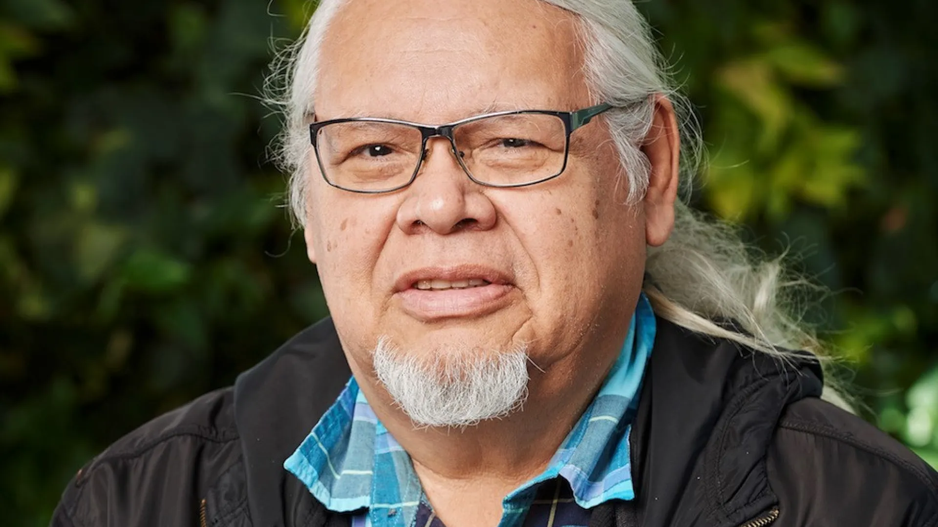 Photo of Rick Hill Sr, wearing glasses with white hair and short beard