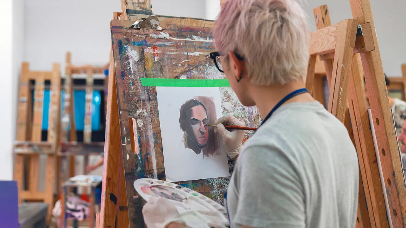 Person painting at an easel