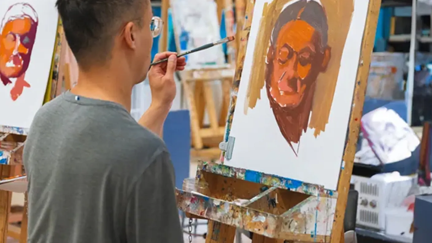Student painting on an easel