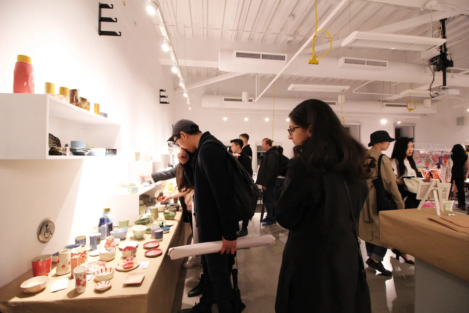 People viewing art for sale at a marketplace